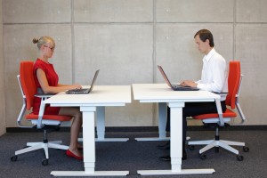 man and lady sitting at desks